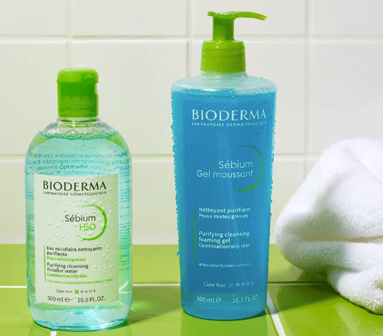 two Bioderma Sebium products with a bathroom tile background.