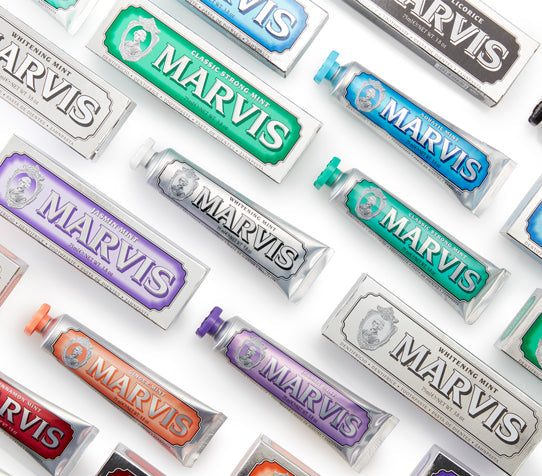 Different flavors of Marvis toothpaste lined up in a diagonal pattern.
