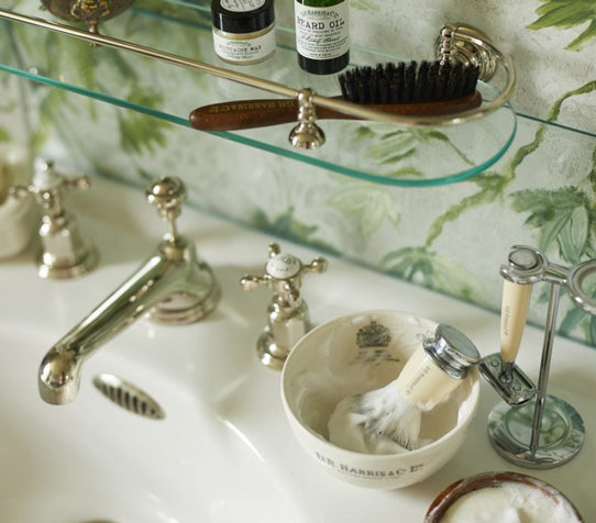 A DR Harris shaving bowl resting on a elegant sink.