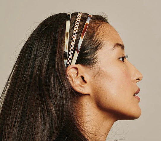 A woman wearing three France Luxe Head Bands.