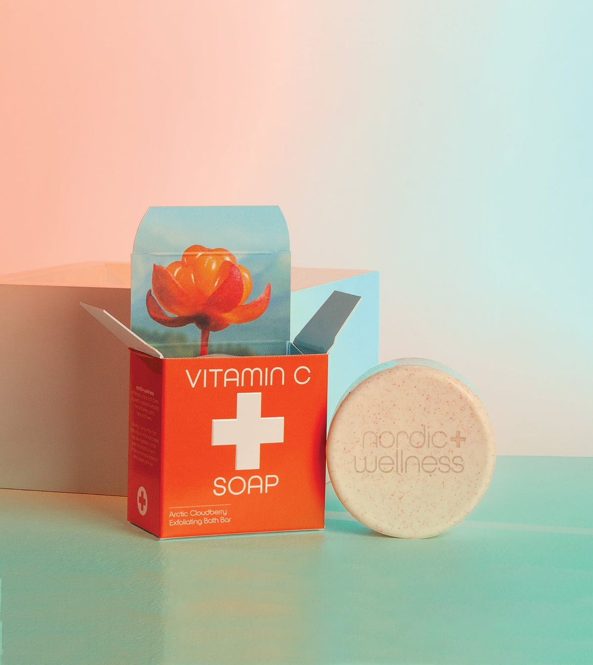 Kala's Vitamin C Bar Soap next to it's box with an orange flower coming out of the top of the box.