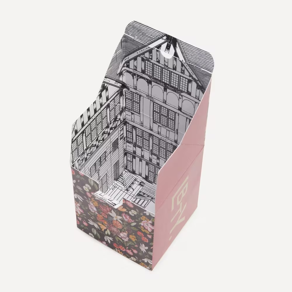 Cardboard box with architectural design on the interior in front of a white background