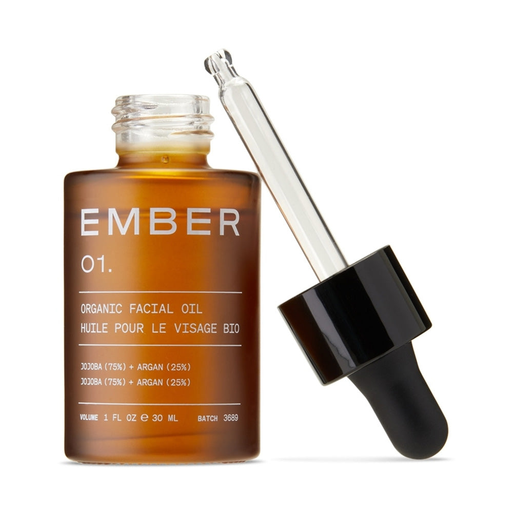 Bottle of Ember Wellness 01 / Facial Oil  with its dropper applicator off and leaning against the bottle.