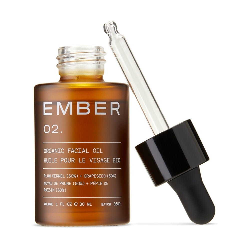 Ember Wellnes 02 / Facial Oil bottle with its dropper top off and leaning against the bottle.