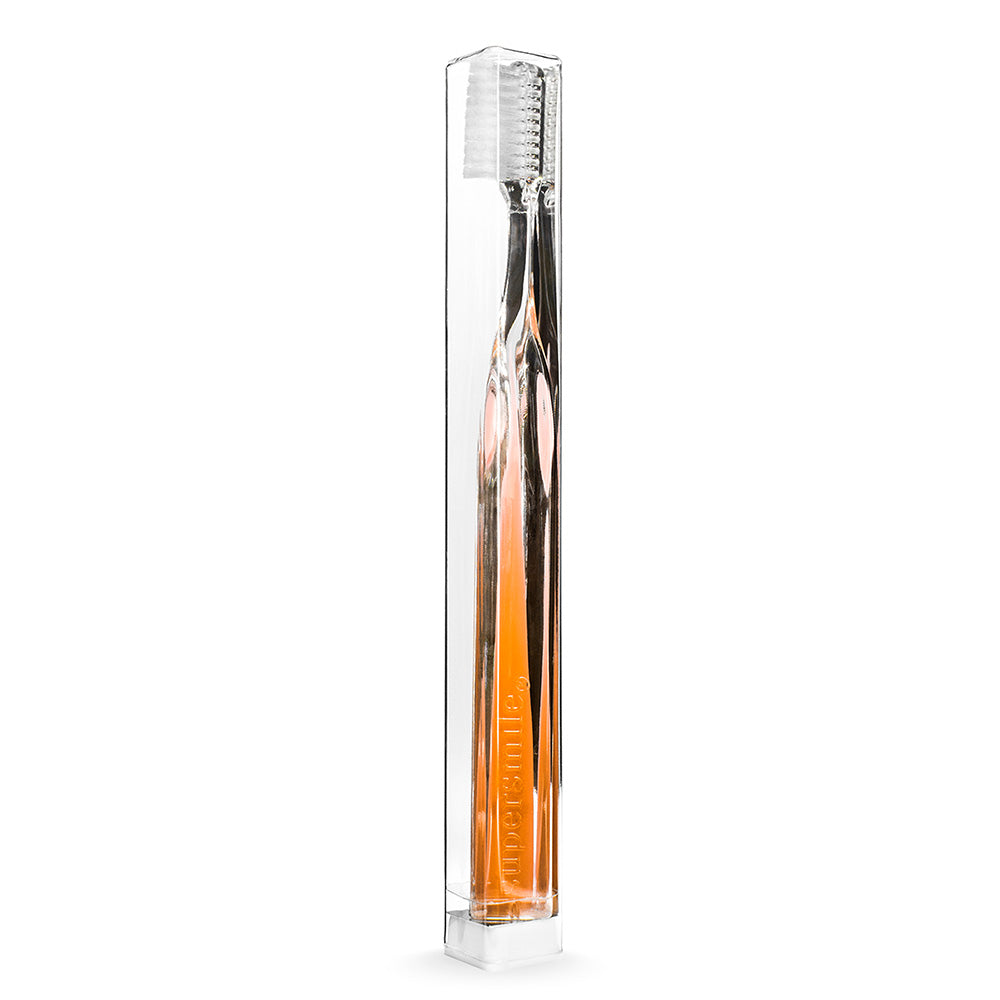 Supersmile packaging with a toothbrush inside on a white background