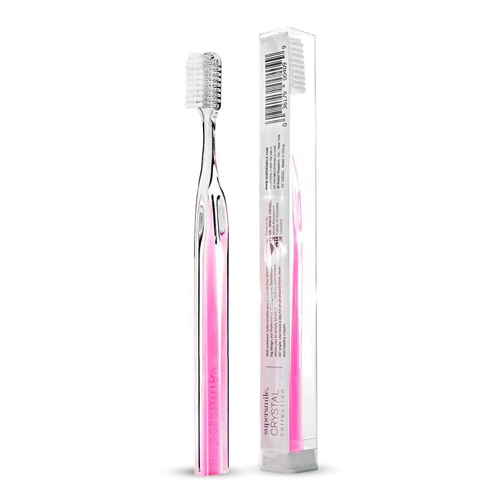 Supersmile tooth brush with pink handle and clear packaging on a white background