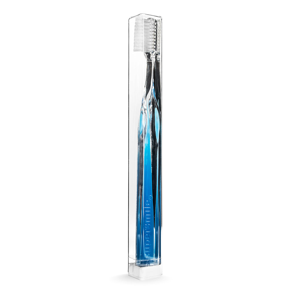 Supersmile Blue toothbrush in a clear packaging box on a white background