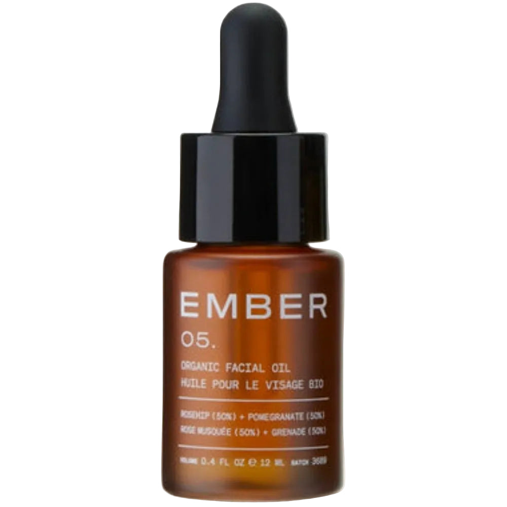 Brown facial oil dropper bottle with black cap on a white background