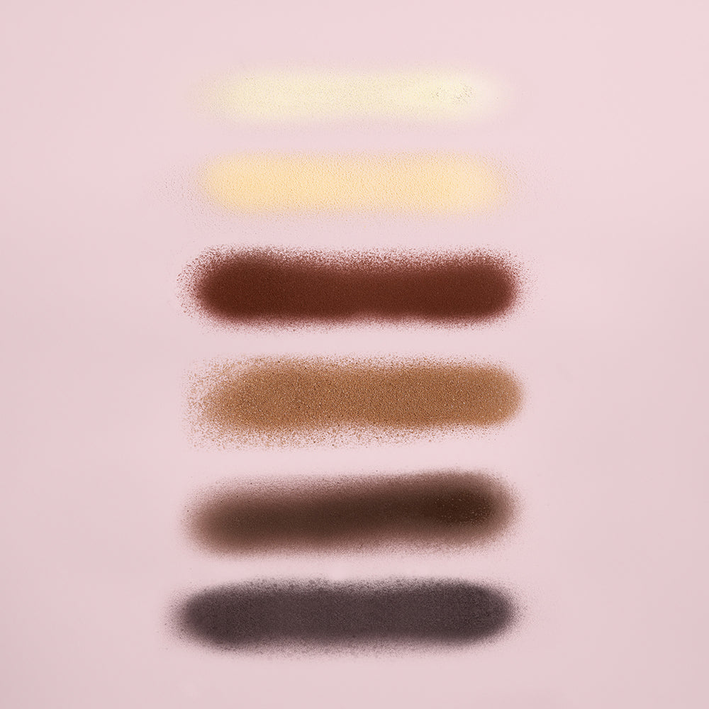 Oribe airbrush touch-up spray - colors sprayed out next to each other in a line.