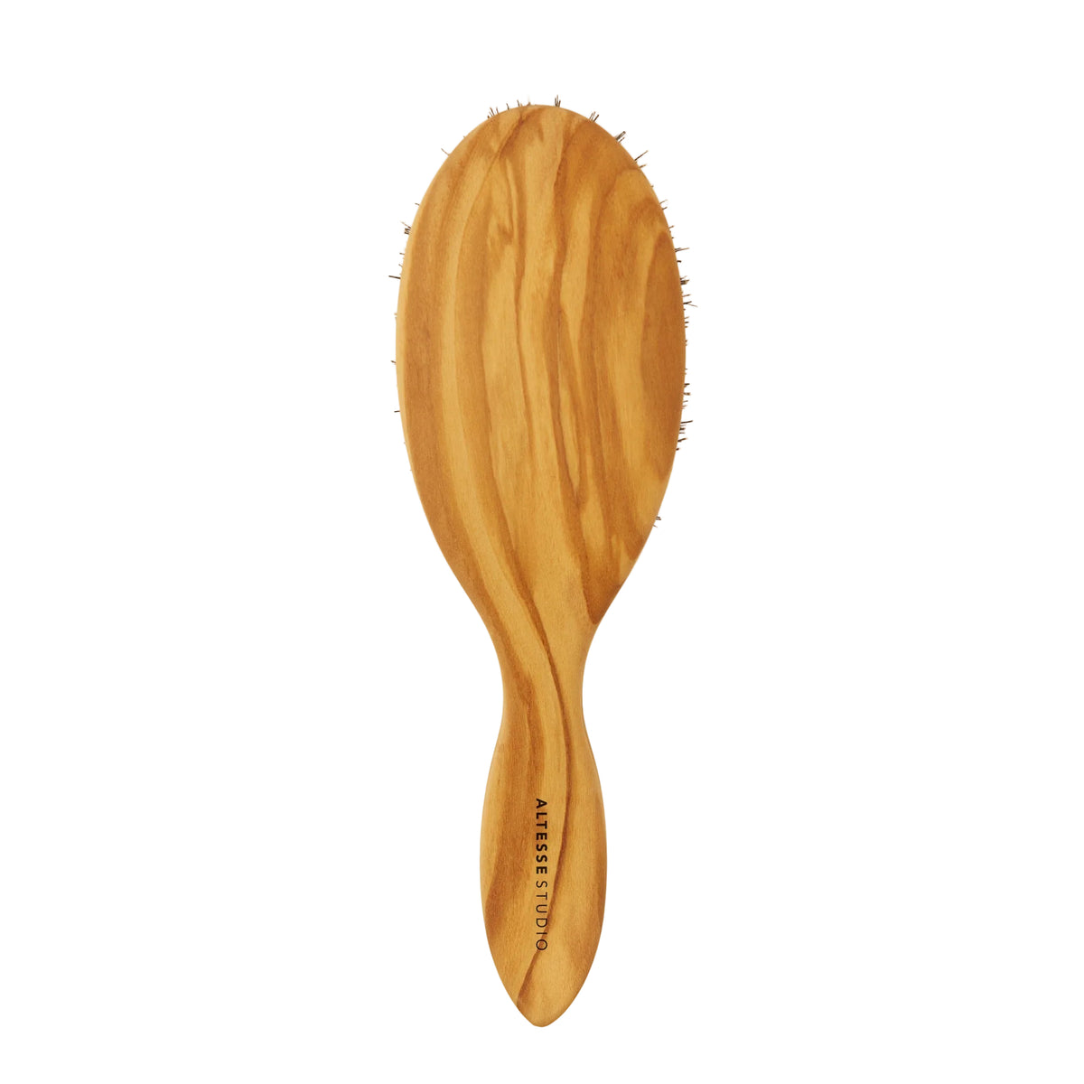 An oval wooden hairbrush with a natural olive wood grain finish and dark bristles, featuring the brand name  printed vertically on the handle, set against a plain off-white background.
