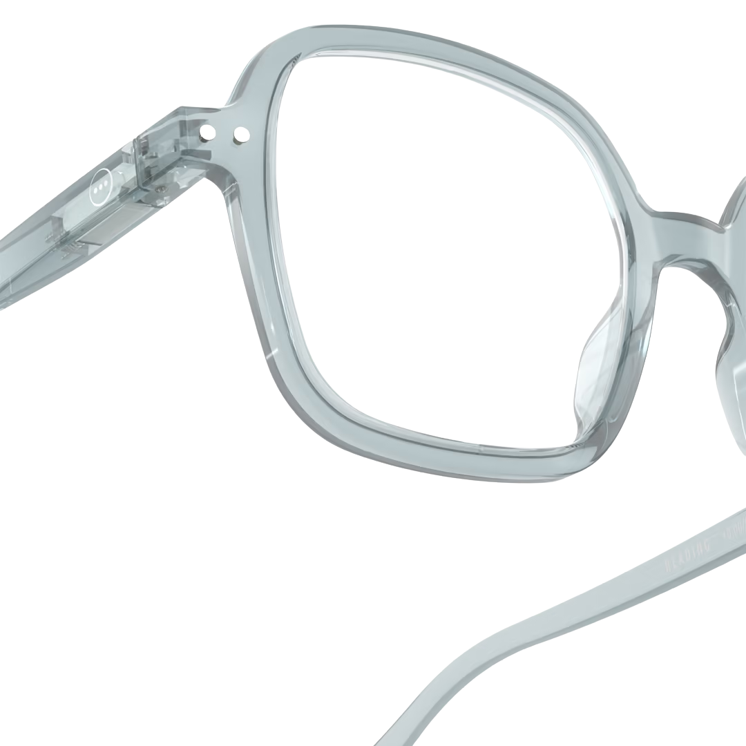 Close-up of a pair of eyeglasses with a clear lens on a white background