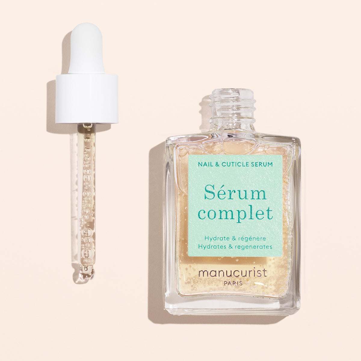 Manucurist Complete Serum and dropper on pink background 
