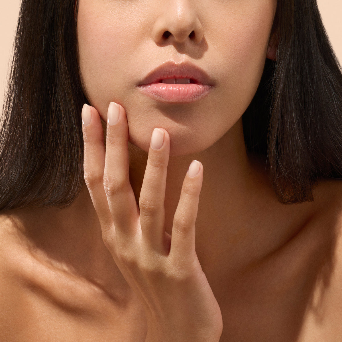 Model wearing Active Smooth 01 while hand rest on chin on tan background 