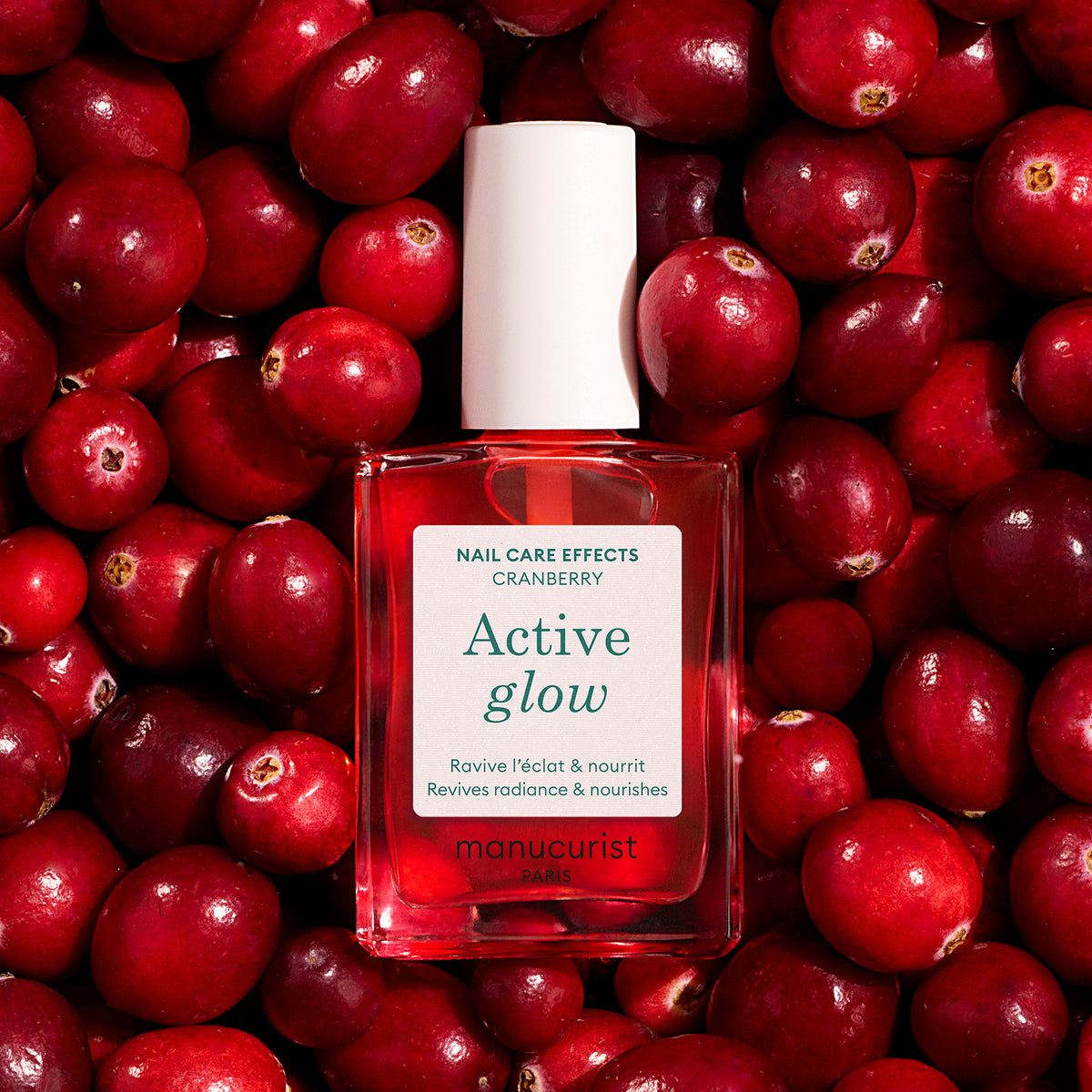 Manucurist Active Glow Cranberry shade alongside background of cranberries 