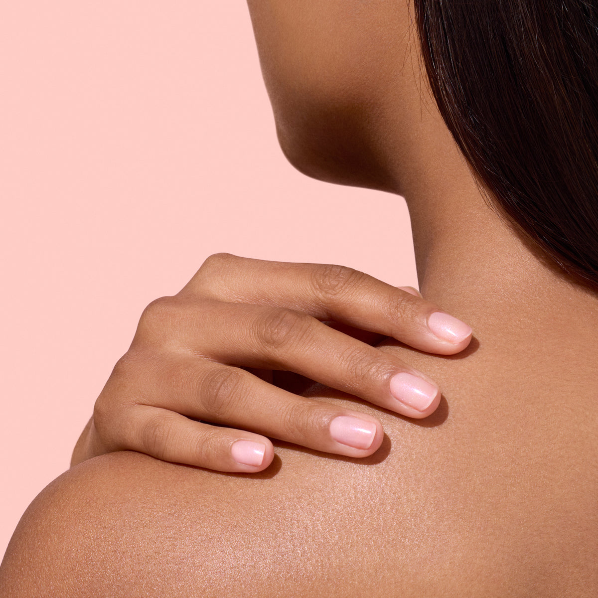 Tan Shade hand on shoulder wearing Manucurist Active Plump 