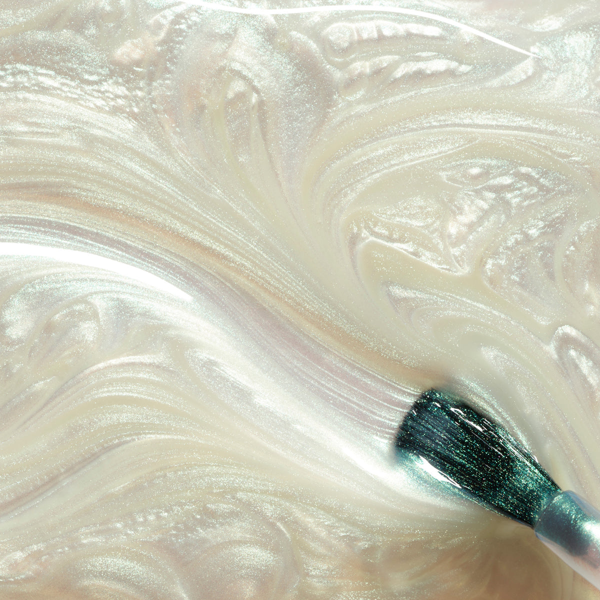 Close-up of Fairy glittery nail polish on a white and beige swatch.