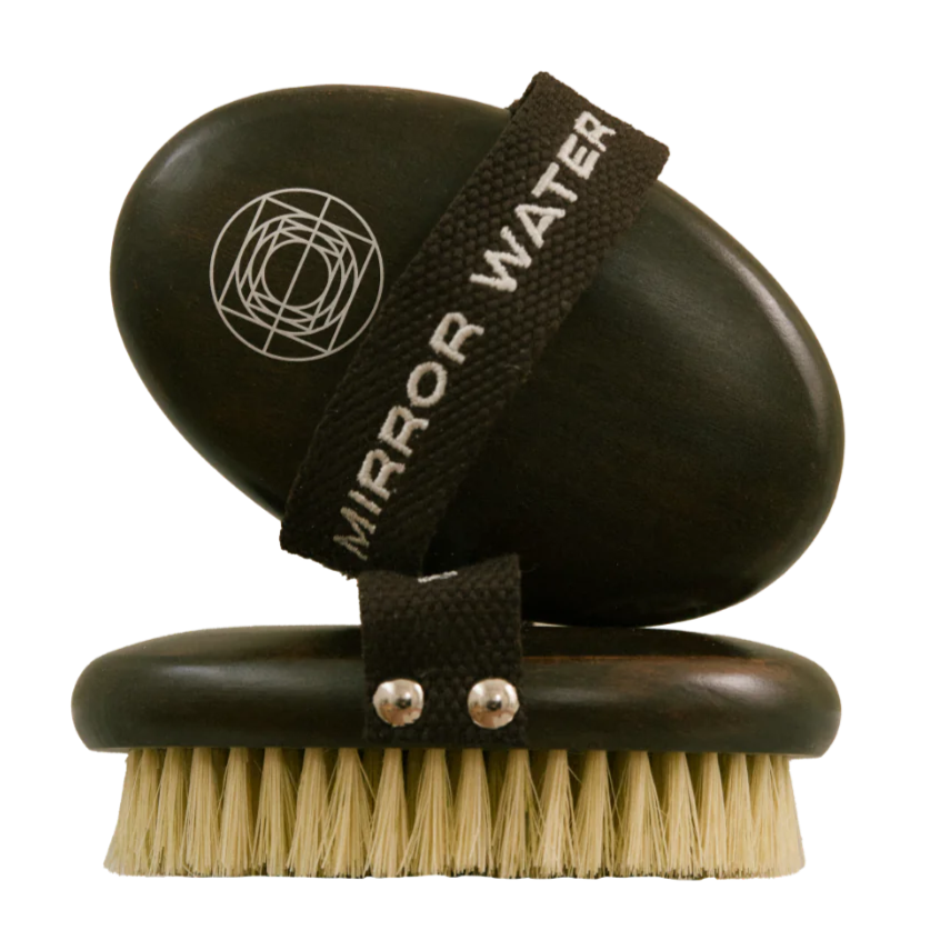 Mirror Water Dry Brush.  Shows the dry oval shaped hand brush from two angles: The side view to see the natural bristles and the back view of the hand strap. 