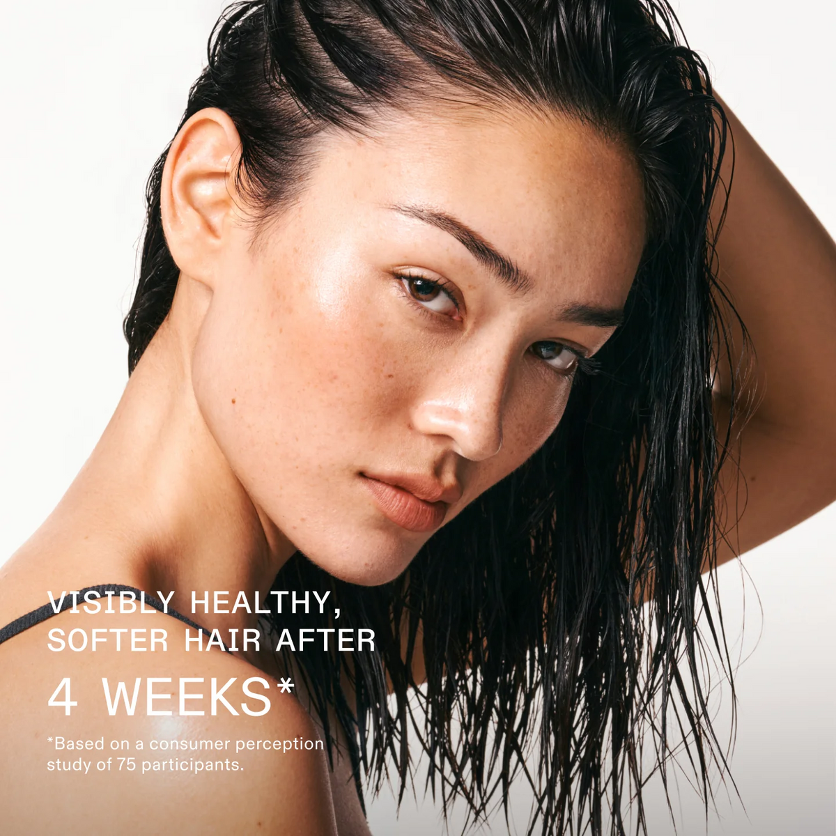 Woman with wet hair looking away from the camera on a white background