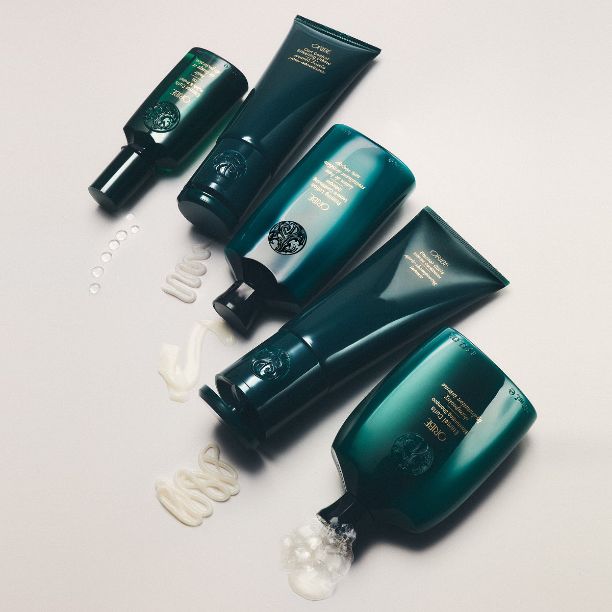 Set of green haircare products on a light background