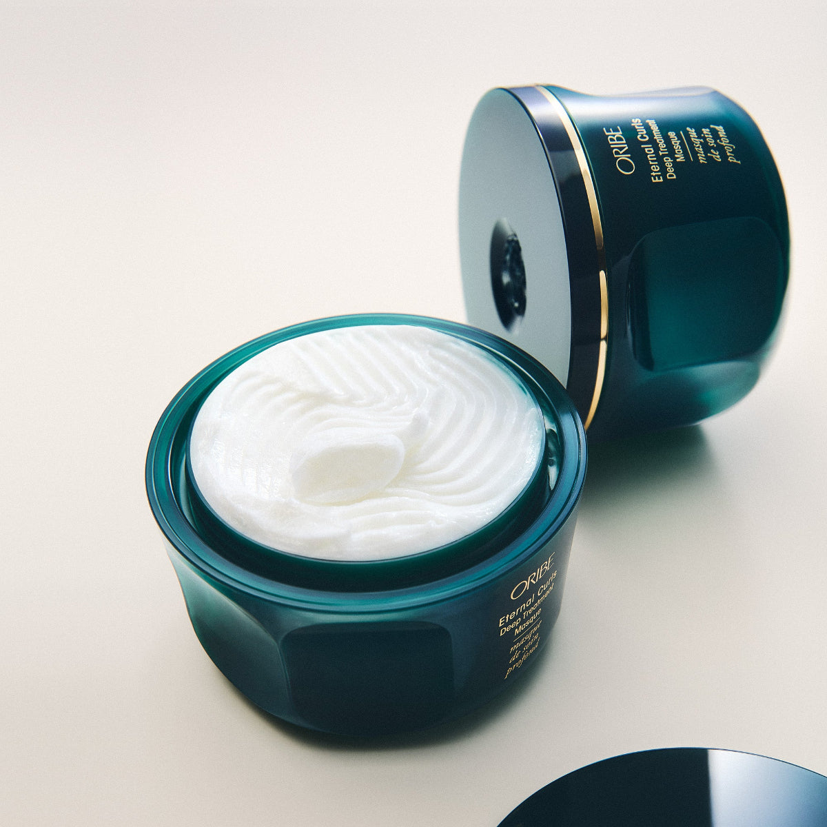 Open jar of Orlane cream on a white background