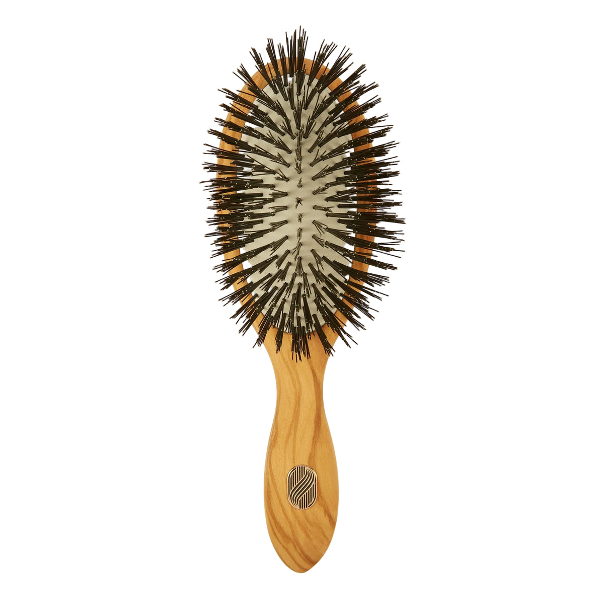 An oval-shaped hairbrush with a light natural wood handle and dark brown to black bristles, shown against a plain off-white background.