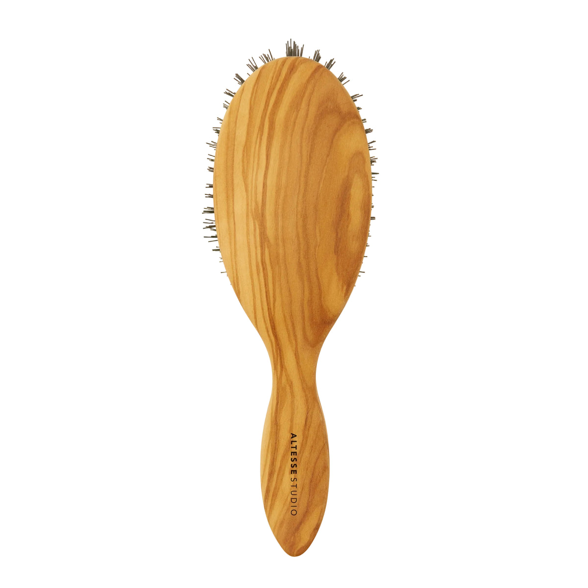 An oval wooden hairbrush with a natural olive wood grain handle and dark bristles, shown against a solid off-white background. The brand name  is printed vertically on the handle.