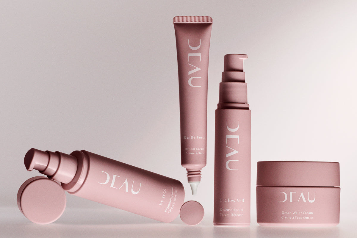 Set of pink skincare products with 'DEAU' branding on a light gray background