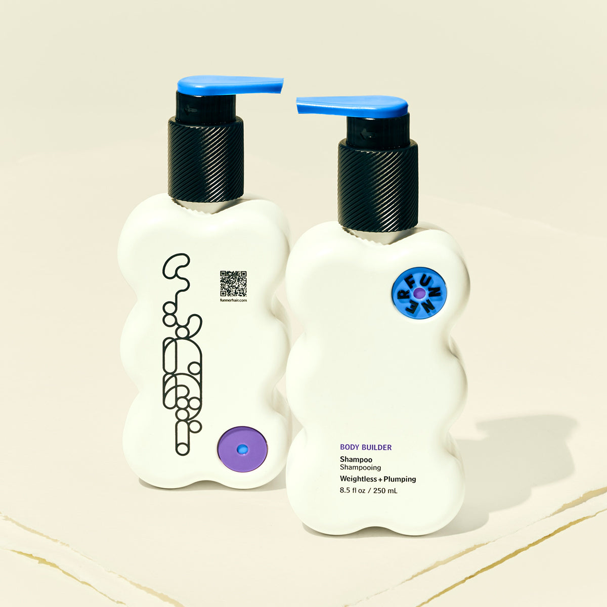 Two white bottles with black pumps and colorful labels on a beige background