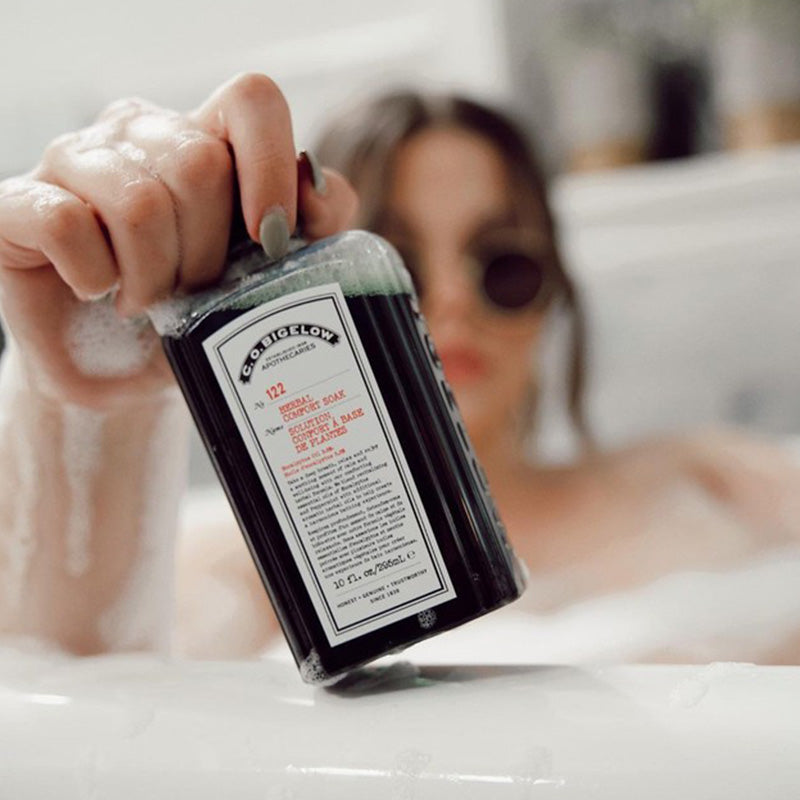 CO Bigelow Herbal Comfort Soak being held by women in tub 
