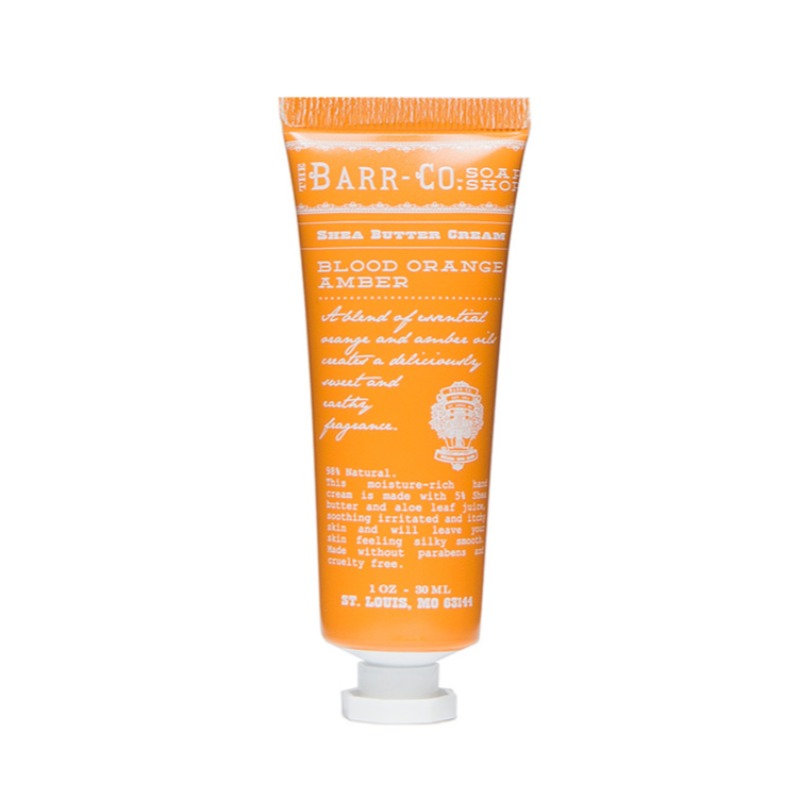 A tube of hand cream with a label that reads 'Barr-Co.', 'Shea Butter Hand Cream - Blood Orange Amber', and has orange color detailing.