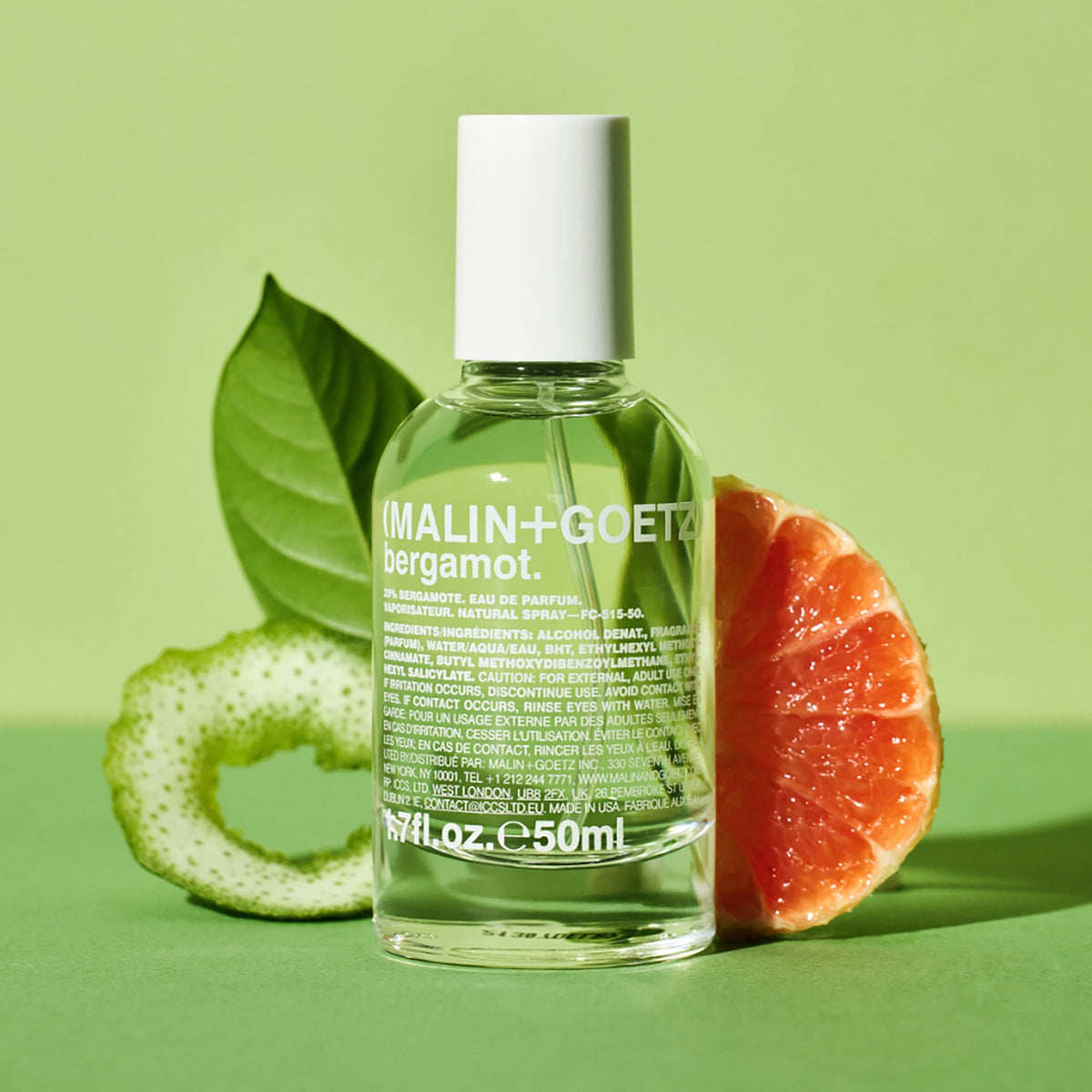 MALIN+GOETZ bergamot perfume bottle with a green background