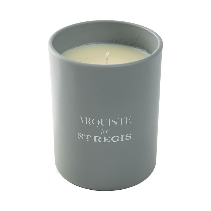 A gray scented candle with the ARQUISTE brand logo and 'for ST REGIS' text on it.
