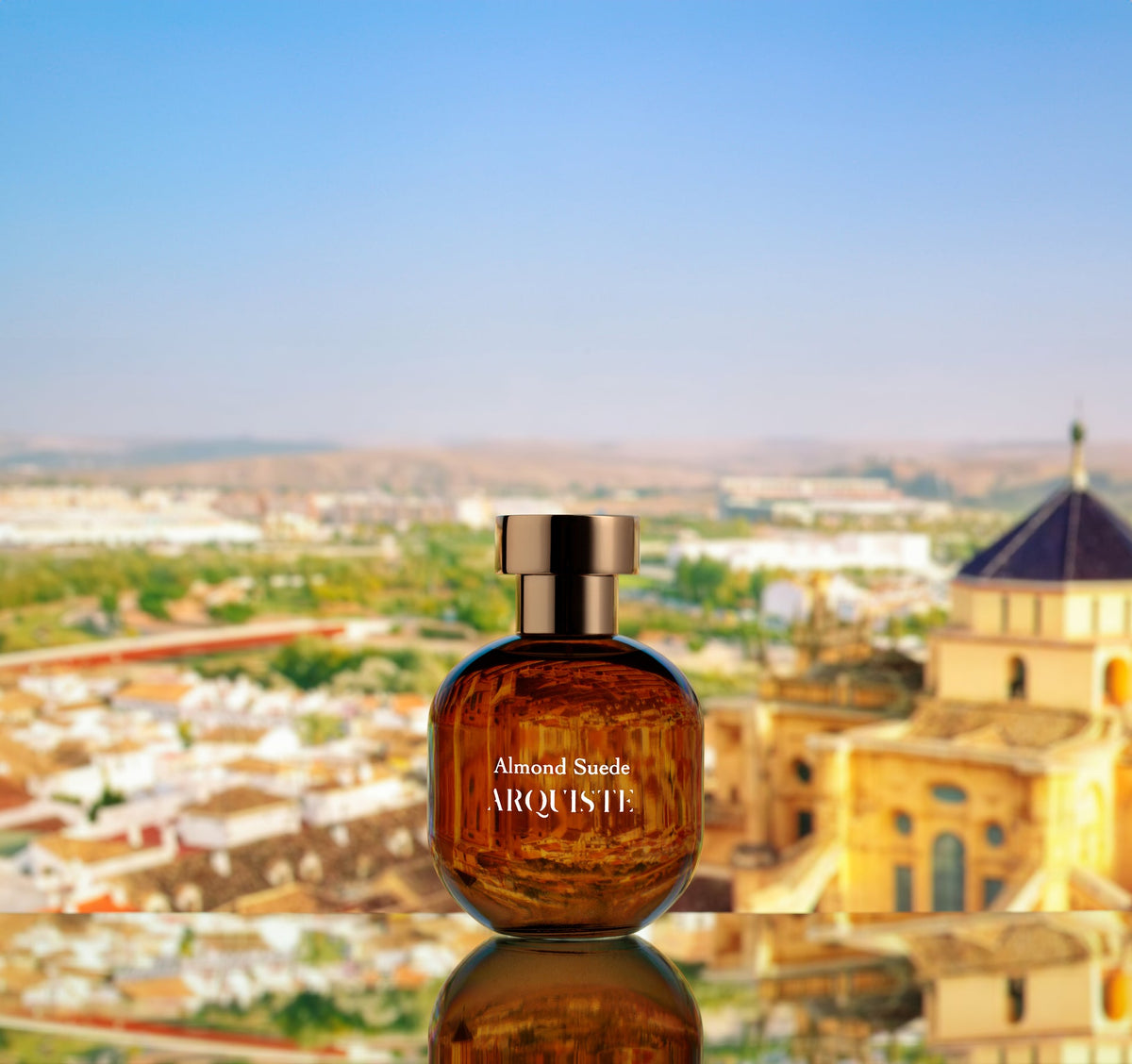 Almond Suede perfume bottle in front of a cityscape