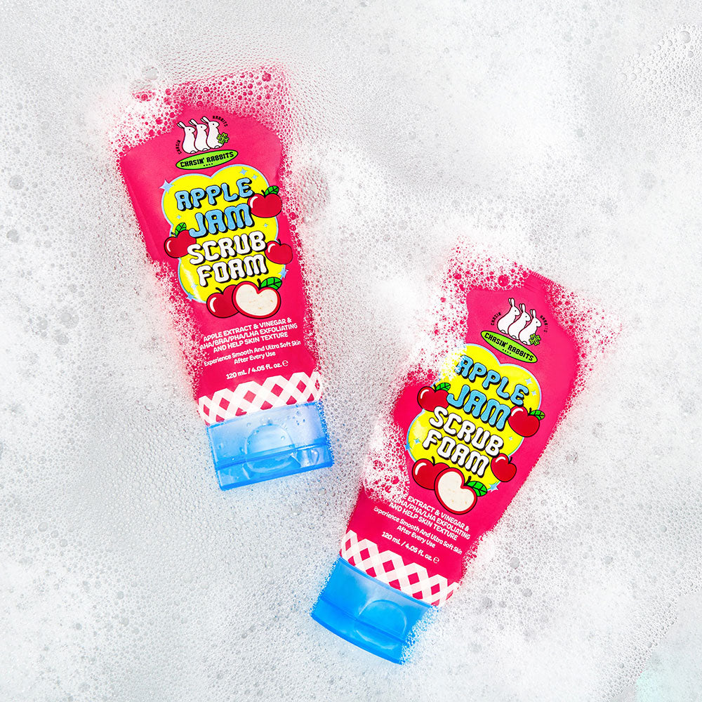 Two tubes of Apple Jam Scrub Foam on a white background with foam around them.