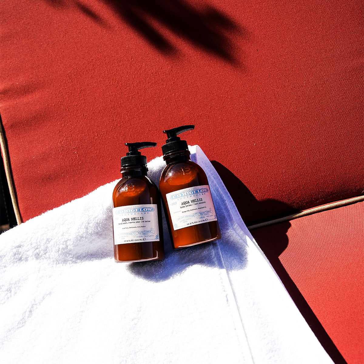 C.O. Bigelow Iconic Collection Aqua Mellis Body Lotion and Hand Wash on a towel on top of a red cushion. 