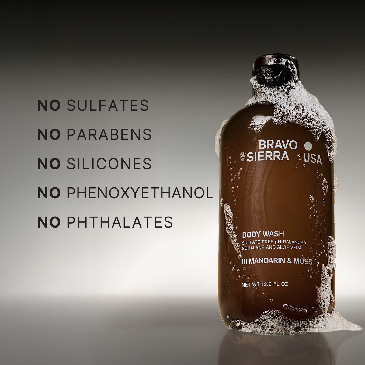 Bottle of Bravo Sierra body wash with text highlighting ingredients on a gradient background