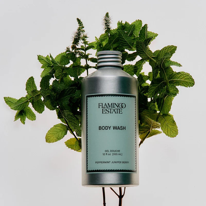 Flamingo Estate body wash bottle with green mint leaves on a light gray background