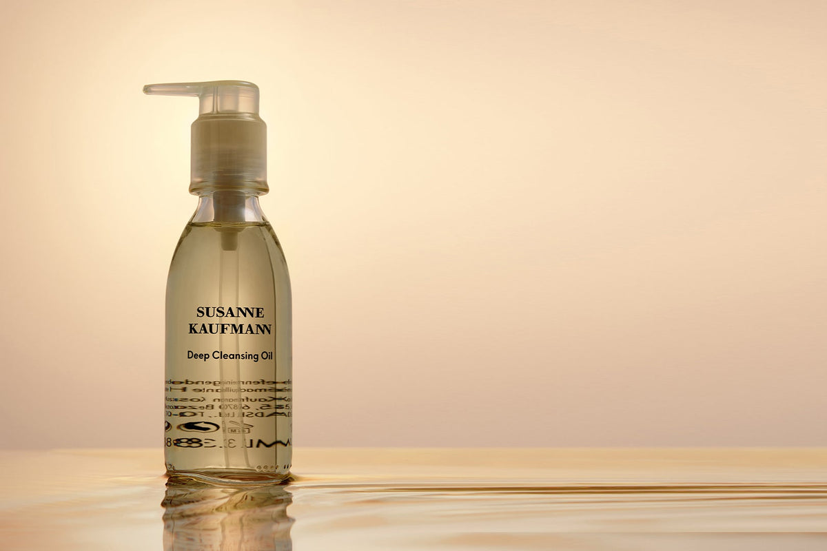Bottle of Susanne Kaufmann Deep Cleansing Oil on a beige background