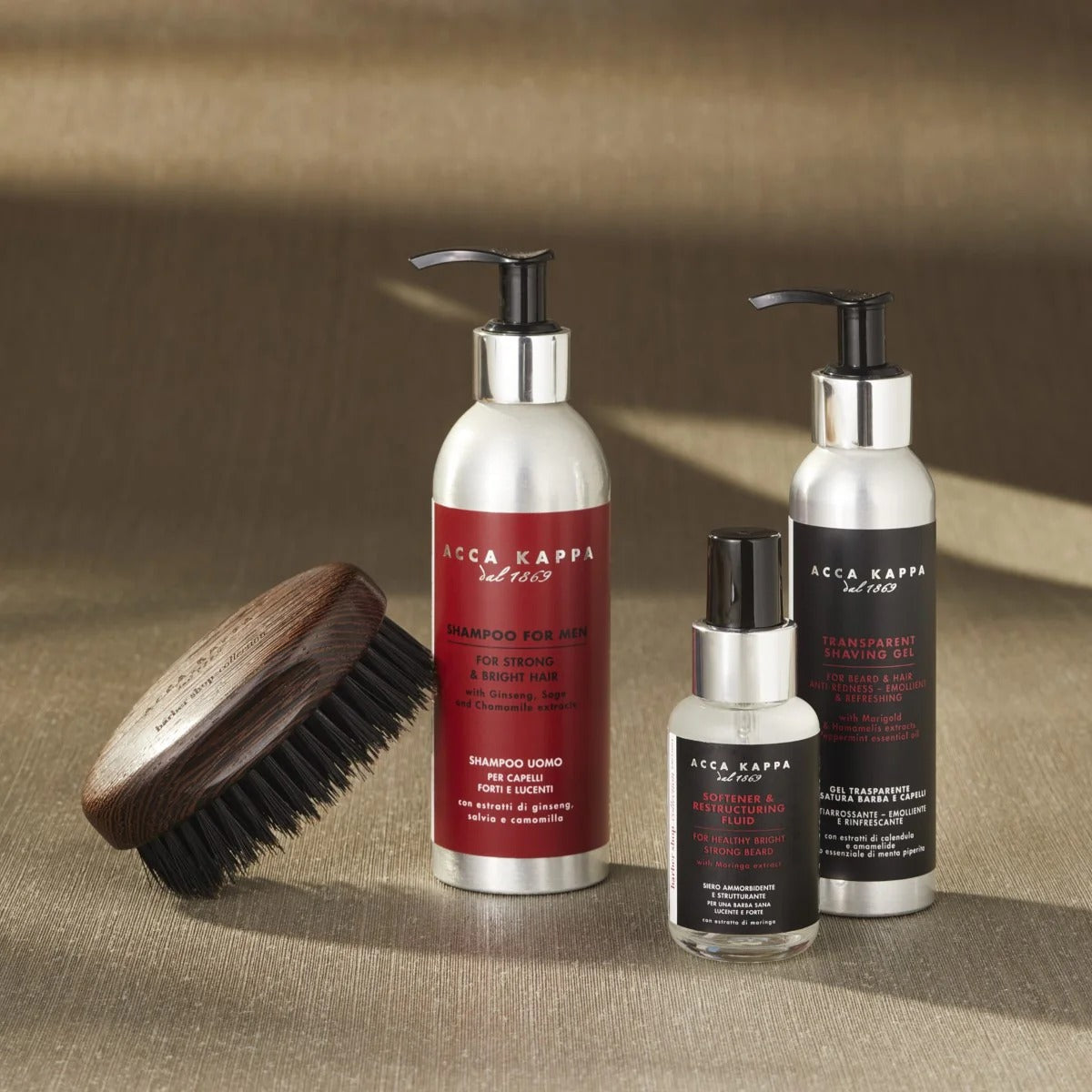 Acca Kappa grooming products including a brush, shampoo, and conditioner on a textured surface.