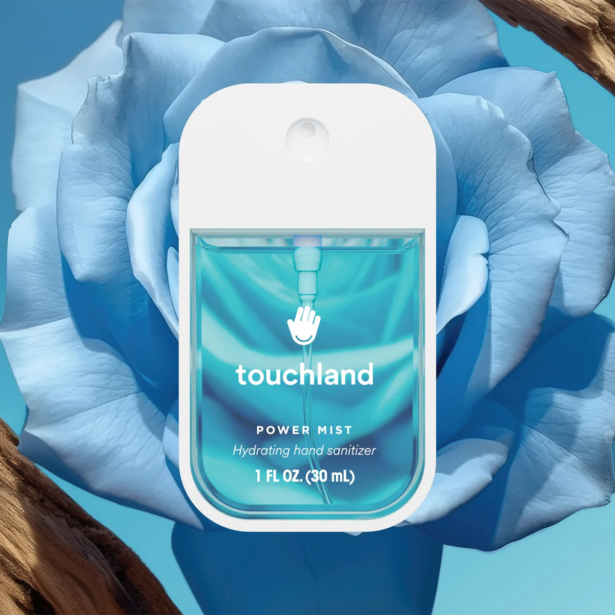 Touchland Power Mist Hydrating Hand Sanitizer - Blue Sandalwood, centered against a large light blue flower with brown wood elements in the corners.