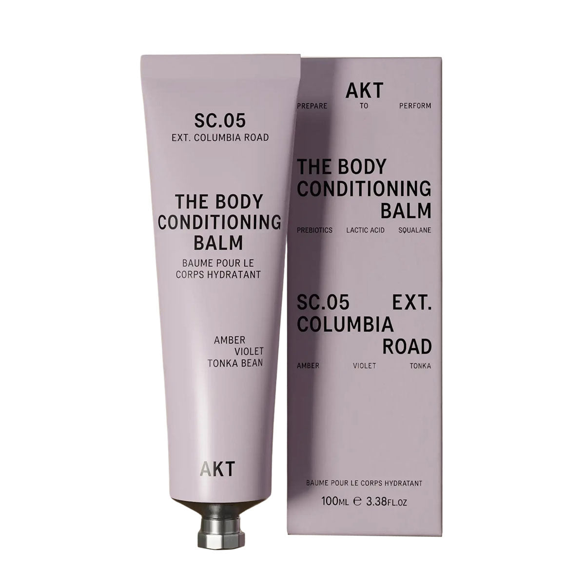 AKT's Columbia Road Body Conditioning Balm tube is to the left of its lilac-colored packaging box, in front of a white background.