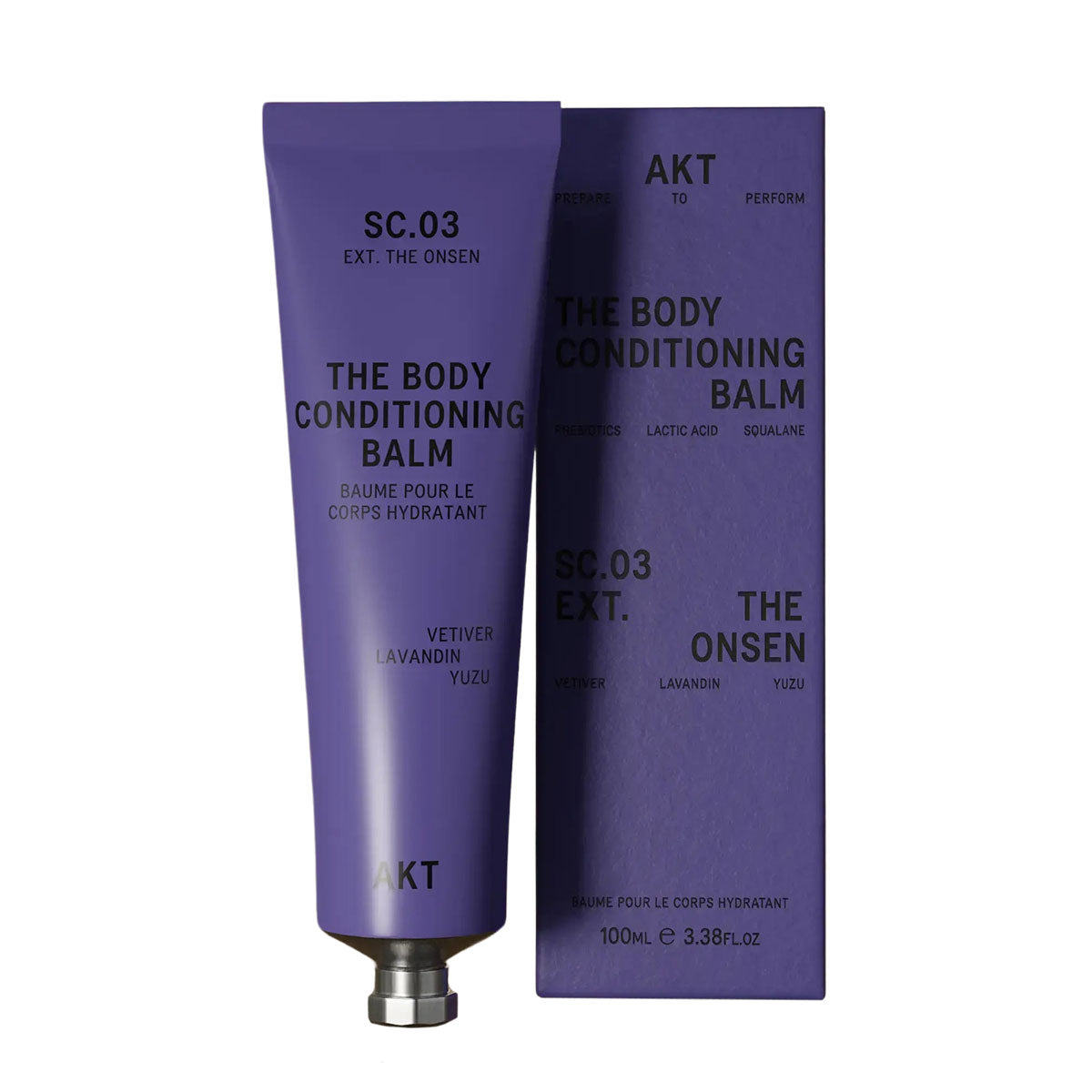 AKT's The Onsen Body Conditioning Balm tube to the left of it's dark purple packaging box in front of a white background.