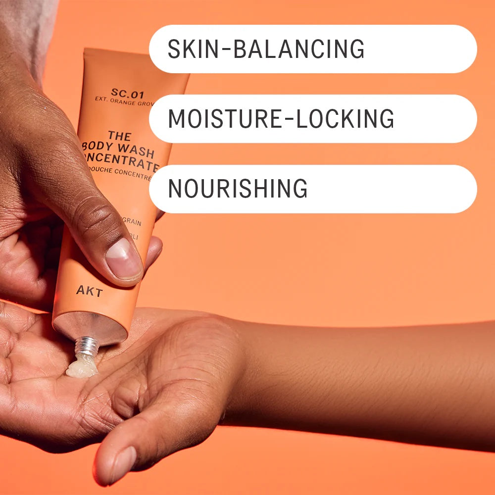 Hands squeezing AKT's Body Wash Concentrate onto the palm of their hands. Text overlaid on the image reads: "Skin Balancing, moisture-locking, nourishing."