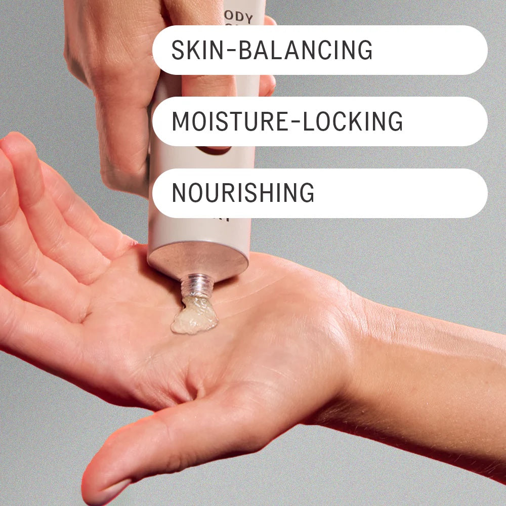 AKT's Body Wash Concentrate being squeezed onto palm of a person's hands. Text overlaid on image reads: "Skin-Balancing, Moisture-Locking, Nourishing."