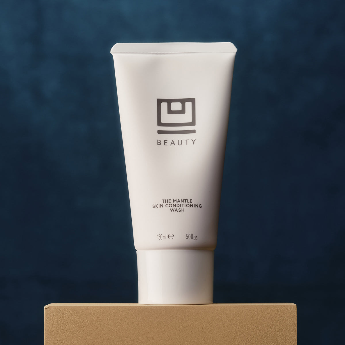U Beauty's The MANTLE Skin Conditioning Wash on a pedestal.