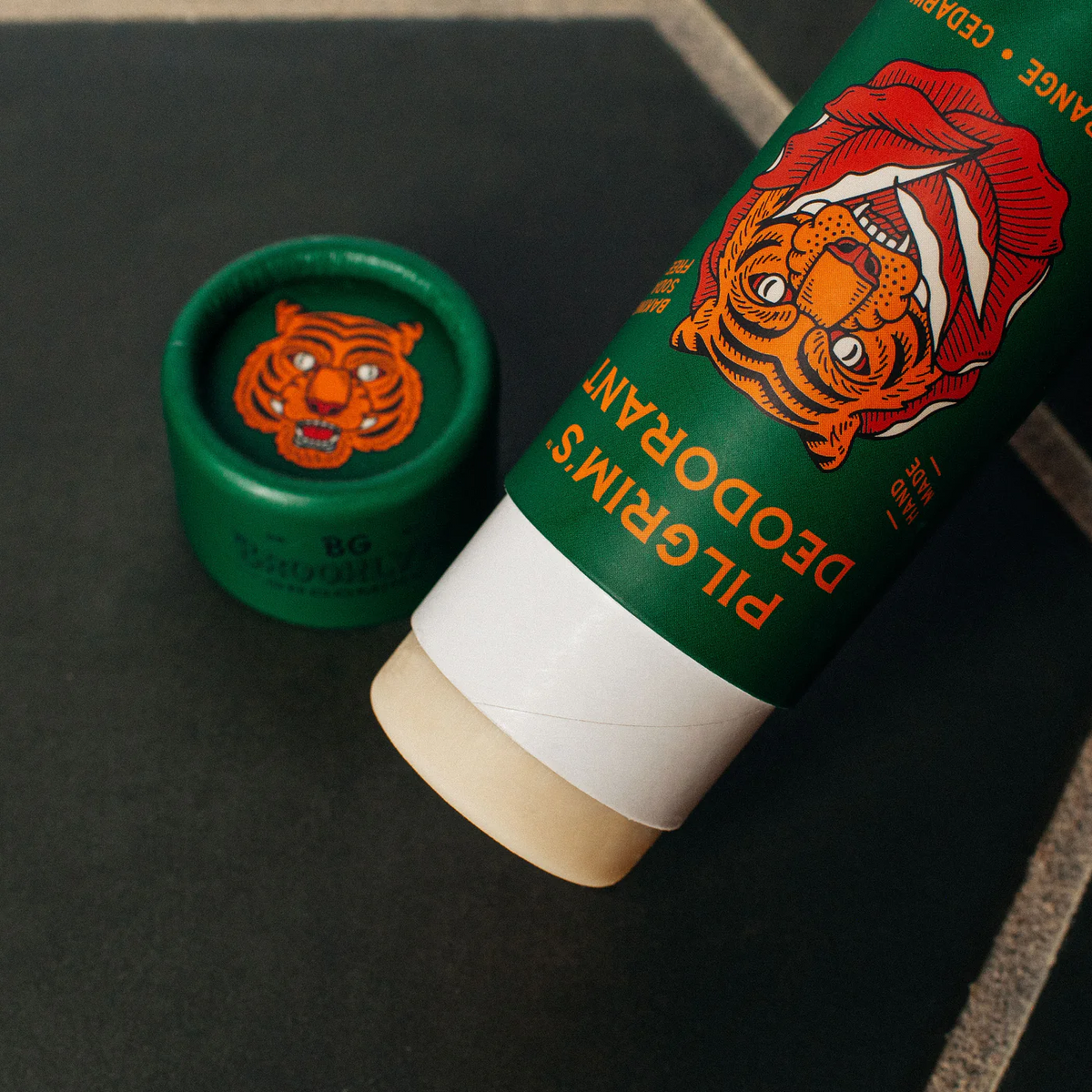Green deodorant stick with tiger design on a black background