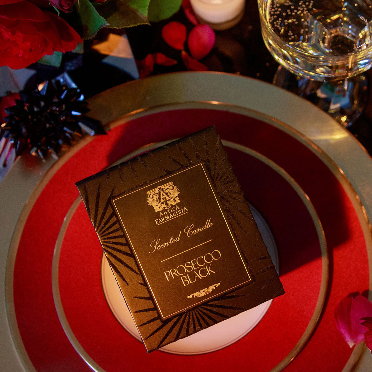 Boxed candle on top of a red plate