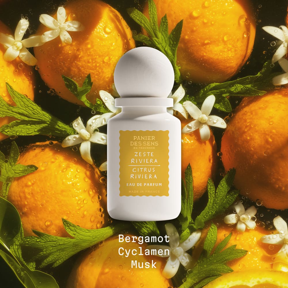White perfume bottle Citrus Riveria with floral and citrus elements on a dark background