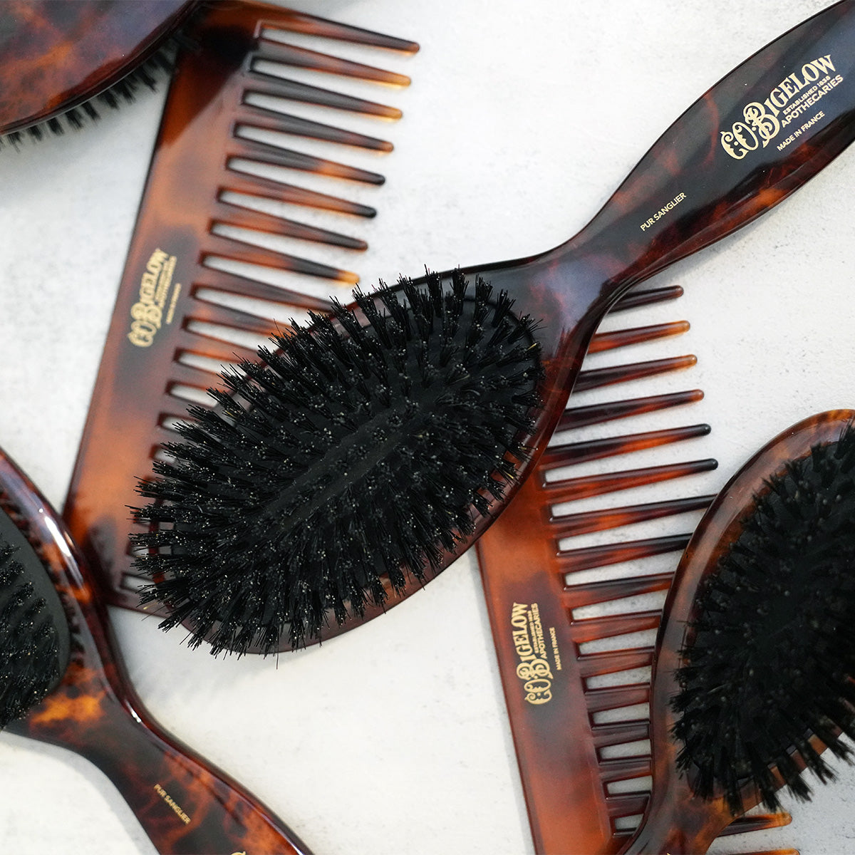 C.O. Bigelow tortoiseshell hairbrushes and combs on a light background.