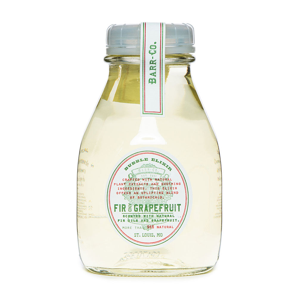 A clear plastic bottle containing a pale yellow liquid, labeled 'Barr Co Bubble Elixir Fir & Grapefruit' with various product details on the label.
